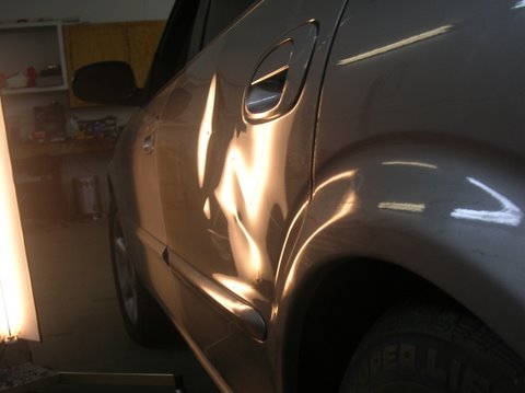 Maxima Door with large dent view 2 before repair